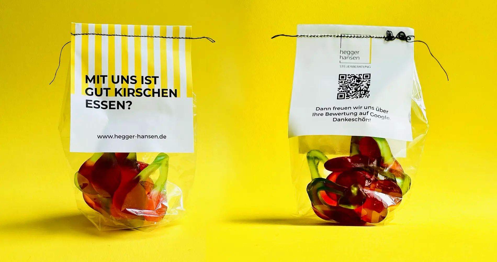 Gebrandete Giveaways der Steuerberatung Hegger Hansen mit Fruchtgummis und humorvoller Botschaft auf Verpackungsetiketten